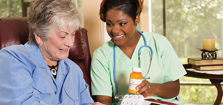 A nurse is helping her patient with meds